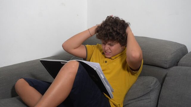12 year old boy child suffering from a migraine headache &ndash; student experiencing head pain and fatigue stress from homework and studying -  Fever, illness, and medical care medicine in childhood
