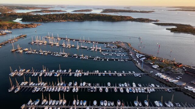 Aerial view of Fiskeback marina with numerous sailboats docked in rows along wooden piers in Gothenburg, Vastra Gotaland County, Sweden.