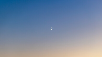 Crescent Moon and Venus in Twilight Sky with Blue to Orange Gradient © CHO KEE HO