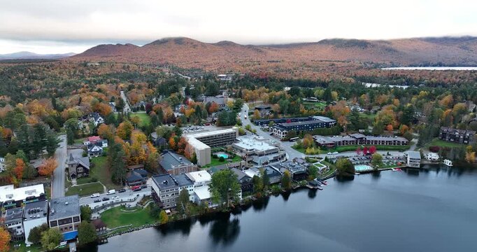 Lakefront hotels and inns on Mirror Lake in Lake Placid, New York with autumn mountains