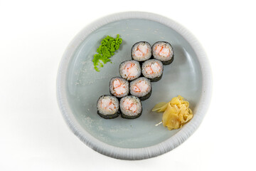 Shrimp maki sushi rolls with wasabi and pickled ginger on white plate, top view, isolated on white background © Evghenii Blanaru