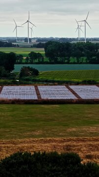 Aerial view of Agriport A7 wind turbines and solar panels in the rural landscape of Middenmeer, Noord-Holland, Netherlands.