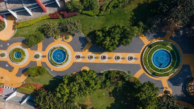 Aerial view of the Pune IT Park featuring circular fountains, geometric patterned walkways, and lush green landscaping in Pune, Maharashtra, India.