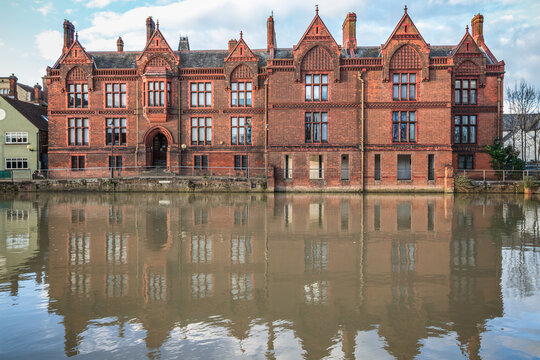 Facade of Shire Hall, currently serving as a civil court building, reflected in the River Great Ouse in Bedford, UK
