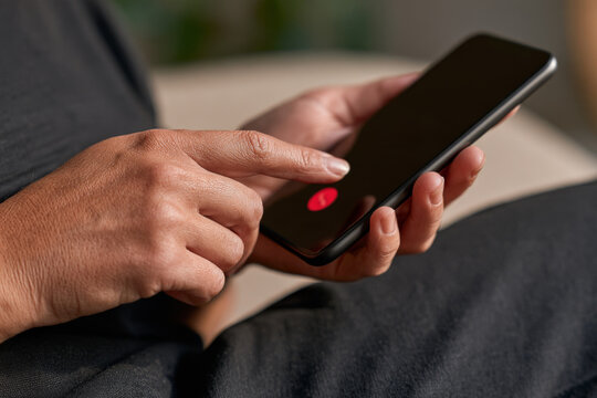 Close up of female hands making an emergency call on a smartphone. Mobile assistance, urgent contact, personal safety, crisis response.
