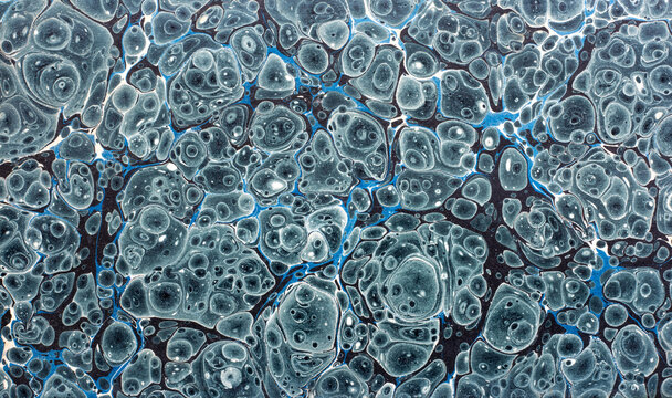 Antique 19th-century handmade paper from an old book, preserved as a richly decorated marbled endpaper. This hand-crafted, hand-marbled, traditional book paper features an intricate ebru pattern.