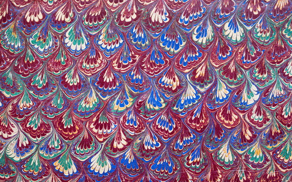Antique 19th-century handmade paper from an old book, preserved as a richly decorated marbled endpaper. This hand-crafted, hand-marbled, traditional book paper features an intricate ebru pattern.
