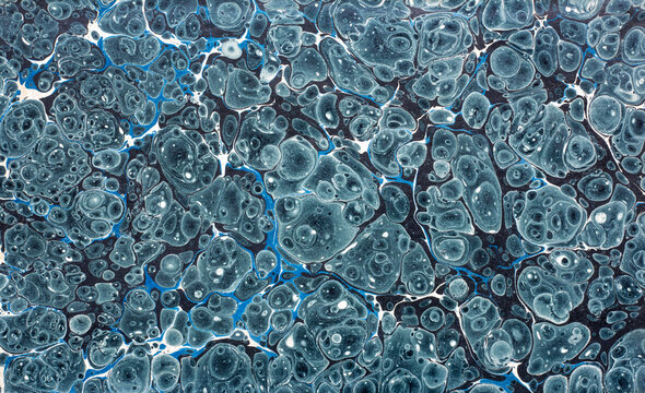 Antique 19th-century handmade paper from an old book, preserved as a richly decorated marbled endpaper. This hand-crafted, hand-marbled, traditional book paper features an intricate ebru pattern .