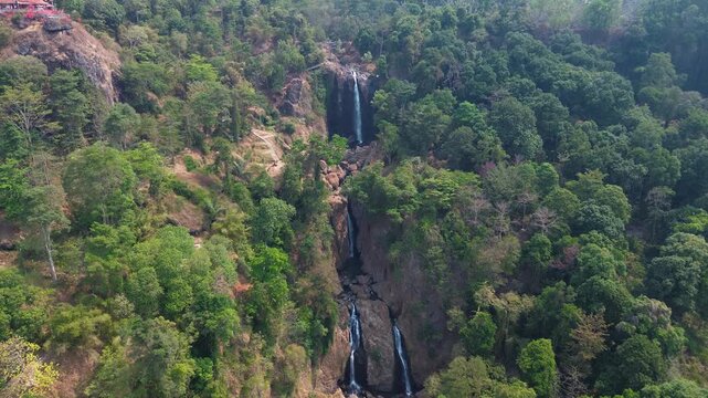 Aerial Drone Footage of Waterfall Flowing Through Lush Tropical Forest