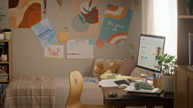 Empty teenager study desk showing computer screen with African American online tutor during video call. Visual ideal for remote learning and educational marketing