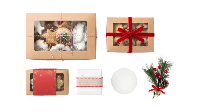 Assorted christmas cookies in gift boxes with festive decorations isolated on transparent background