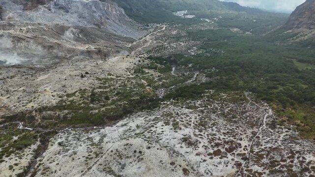 Aerial view of the rugged volcanic terrain and sulfurous deposits of Mount Papandayan in Garut, West Java, Indonesia.
