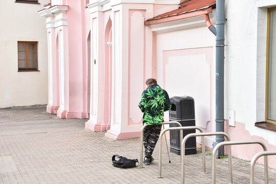 A Man with Camouflage Army Pants and Marihuana Sweater in the Old Town of Vilnius, Lithuania
