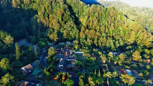 Aerial view of the lush green forest and houses in the Kaliurang area of Pakem, Special Region of Yogyakarta, Indonesia.