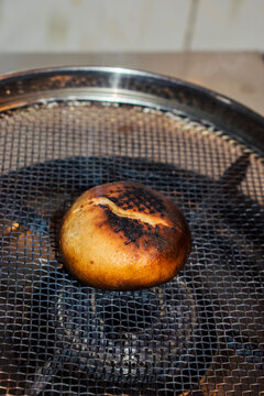 roasting of litti with smoke. vertical image