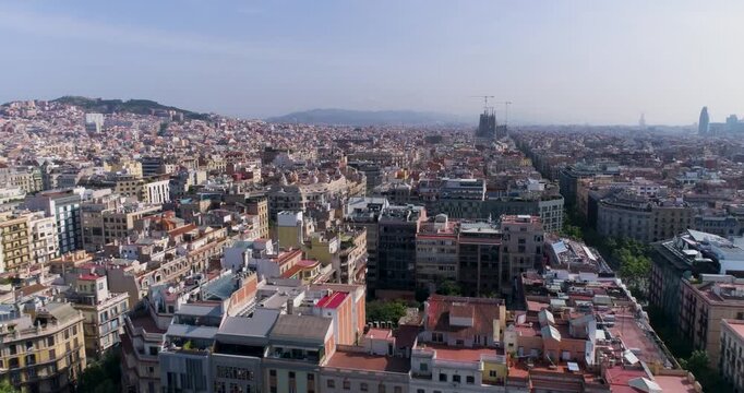 Aerial view of the Eixample district with its iconic grid street layout and historic buildings under a clear sky in Barcelona, Catalonia, Spain.
