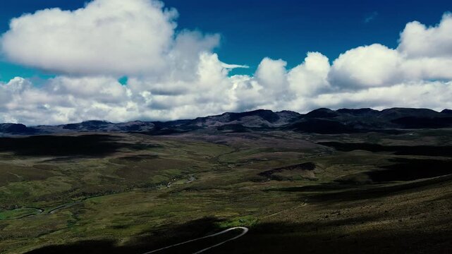Drone footage looks down over Andean p&aacute;ramo grassland in Ecuador, where dense clumps of tan and green tussock grasses form a varied natural pattern. The overhead view captures highland vegetation acro