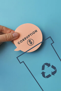A &ldquo;Corruption&rdquo; label above a disposal symbol represents unethical behavior and misconduct.