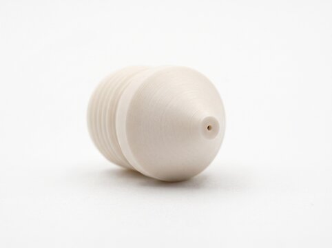 Flame Ionization Detector (FID) jet nozzle for gas chromatography. Micro-machined alumina ceramic cone with fluid delivery orifice isolated on white.