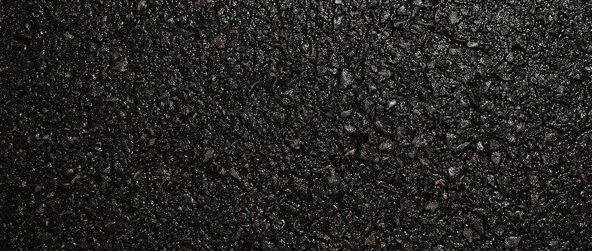 Wet black asphalt night texture. Glossy dark tarmac road surface background after rain