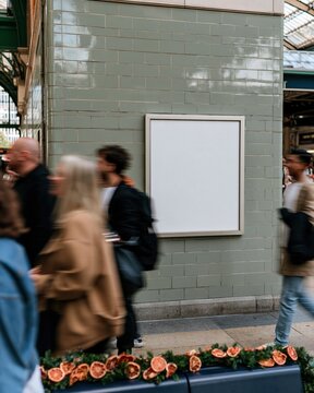 Blank billboard mockup on a glossy sage green tiled wall, featuring a dried orange christmas garland on a bench for holiday advertising