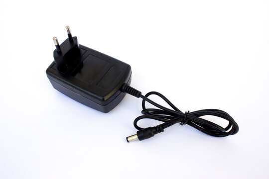 Black AC DC power supply charger adapter with Europlug isolated on white background