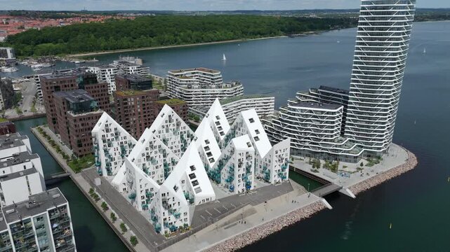 Aerial drone shot showing modern buildings in the Aarhus Docklands neighborhood during daytime in Aarhus, Denmark.