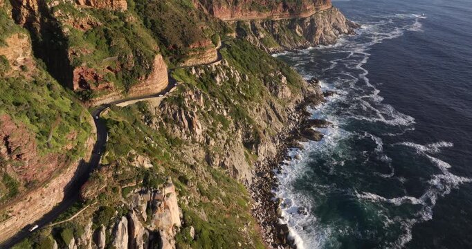 Aerial tilt-down shot of Chapman's Peak Drive between Noordhoek and Hout Bay in Cape Town, Western Cape, South Africa.