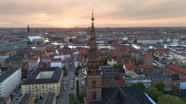 Aerial orbiting shot of the iconic Church of Our Saviour at sunset in the Christianshavn district of Copenhagen, Denmark.