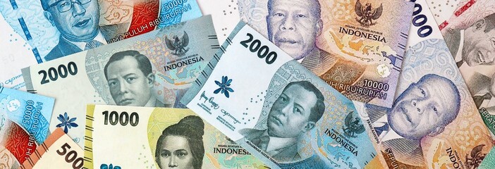 Indonesian rupiah money banknotes bunch on table. Indonesia bills of IDR currency close up © Larysa