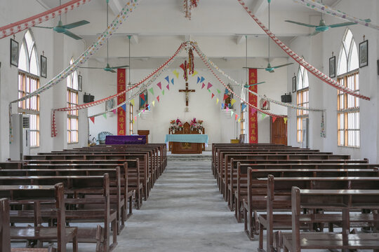 Simple Christian Church Interior with Wooden Pews and Festive Decorations in Dongxing, China