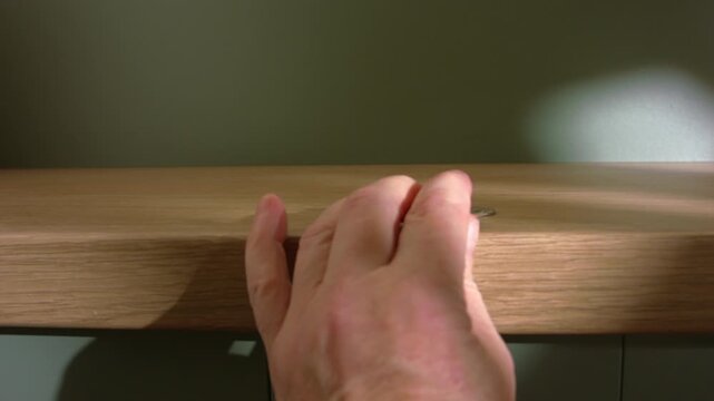 Hand grabbing money coins of table
