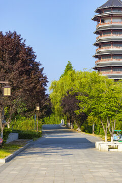 Traditional Chinese Pagoda Tower and Quiet Garden Path in Summer