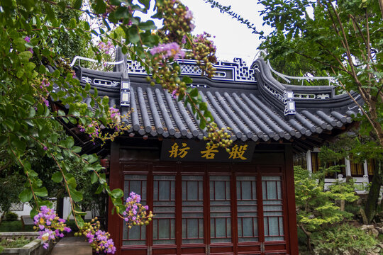 Traditional Chinese Pavilion with Blooming Crape Myrtle Flowers in a Garden
