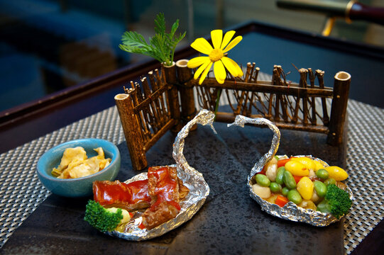 Creative Chinese Food Plating with Swan Foil and Vegetables