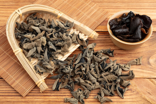 Dried Black Wood Ear Mushrooms in Bamboo Basket on Wooden Table
