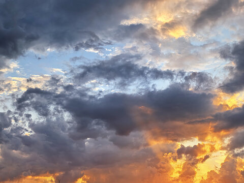 Dramatic Sunset Sky with Dark Clouds and Golden Glow