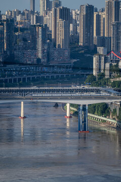 Chongqing city panorama with train crossing river bridge and dense high-rise skyline