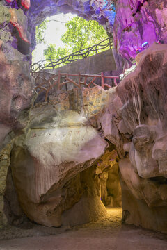 Illuminated Karst Cave Passage with Rock Formations in Pingxiang, Guangxi