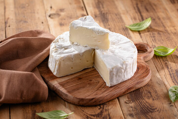 Fresh Brie cheese with herbs. Camembert cheese.
