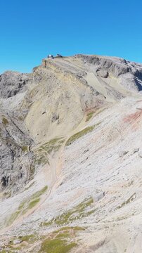 Vertical video from Funivia Lagazuoi above Passo Falzarego, showing rugged high-altitude terrain and panoramic mountain scenery around Piccolo Lagazuoi in the Italian Dolomites.
