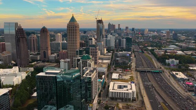 Aerial view of Atlanta city landscape with skyscrapers and road networks and busy highway traffic forming a vital business center and transportation artery.