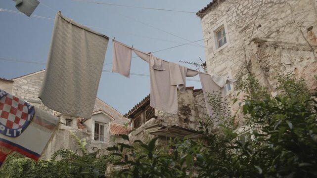 Laundry hanging above a garden in the historic center of Split, Croatia