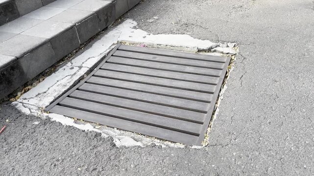 Close-up photo of a street drain cover