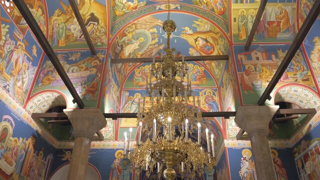 Vibrant frescoes and a magnificent golden chandelier adorn the historic Church of Saints Clement of Ohrid and Panteleimon in Ohrid, Macedonia.