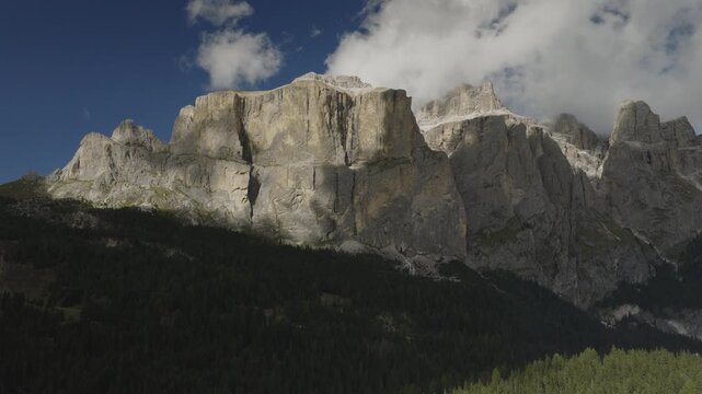 An aerial view of the Sella towers near the Sella pass with clouds after a storm, Canazei, Italy