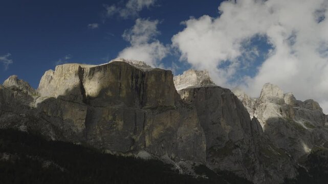 An aerial view of the Sella towers near the Sella pass with clouds after a storm, Canazei, Italy
