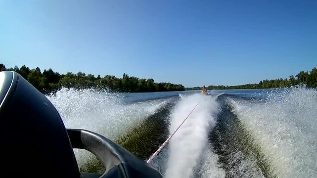 Jet ski towing inflatable banana boat with people