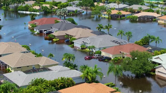 Hurricane flooded cars and homes in residential community in Florida, USA. Aftermath of natural disaster