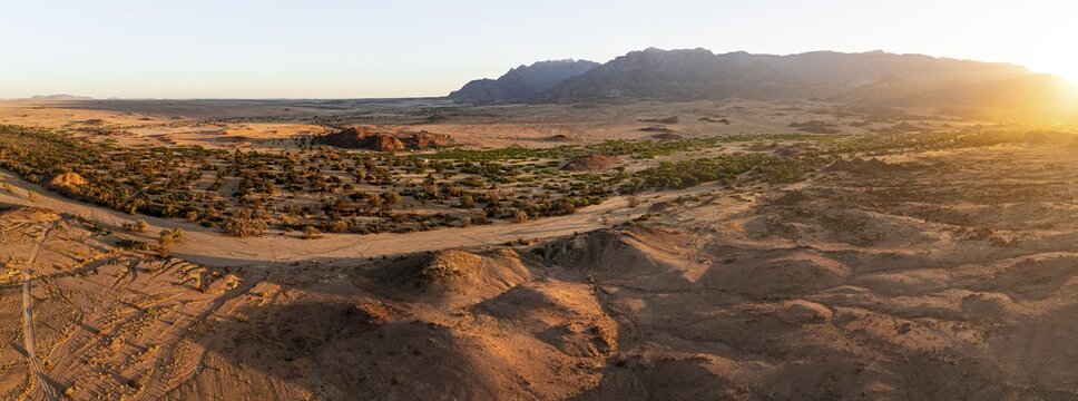 Aerial view, dry riverbed and desert landscape on the Ugab River, behind Brandberg, Erongo, Damaraland, Namibia